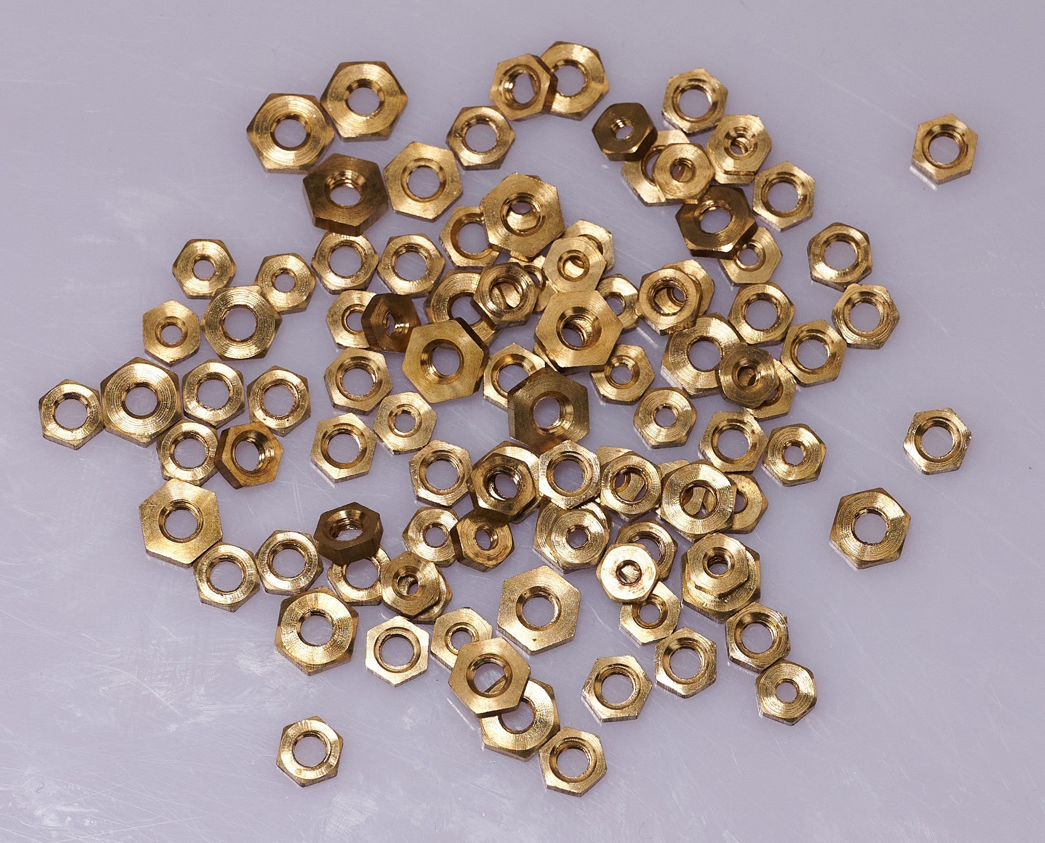 100 BRASS CLOCK NUTS ASSORTED clockmakers parts spares repairs 3-7mm movement
